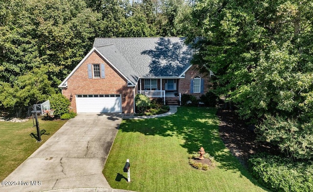 view of front of property with a porch, a front yard, and a garage