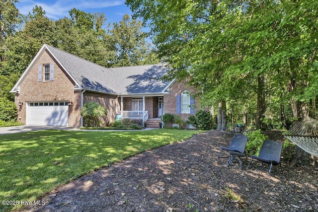 view of front of property featuring covered porch, a garage, and a front yard