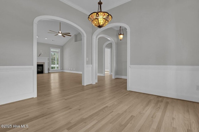 interior space featuring ceiling fan, vaulted ceiling, and light wood-type flooring