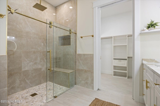 bathroom featuring vanity and a shower with door