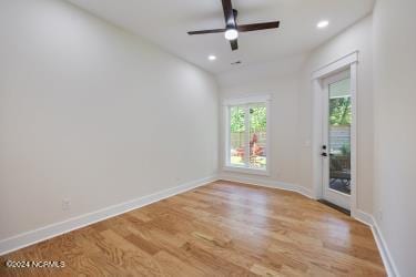 empty room with ceiling fan and light wood-type flooring