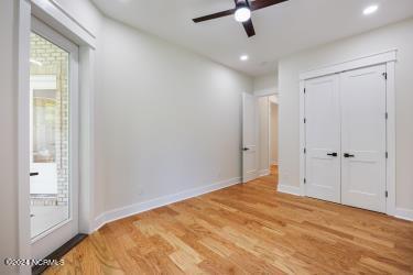 unfurnished bedroom with ceiling fan, a closet, and light hardwood / wood-style flooring