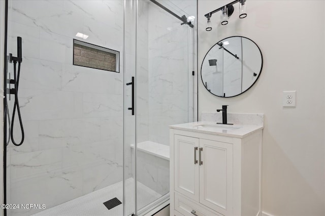 bathroom featuring vanity and a shower with shower door