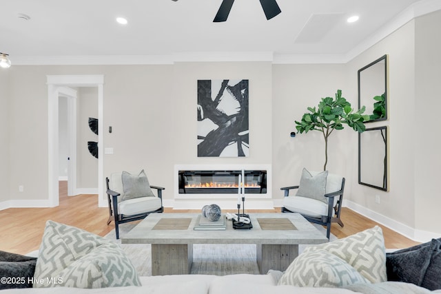 living room featuring ceiling fan, ornamental molding, and hardwood / wood-style floors