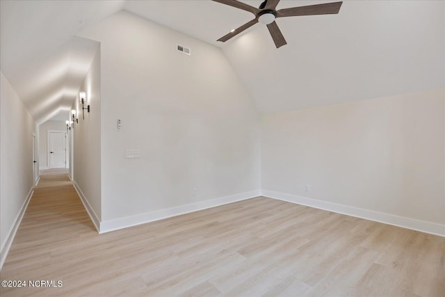 unfurnished room with light hardwood / wood-style flooring, vaulted ceiling, and ceiling fan