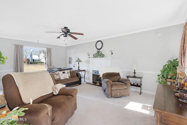 living room with ceiling fan, light colored carpet, and crown molding