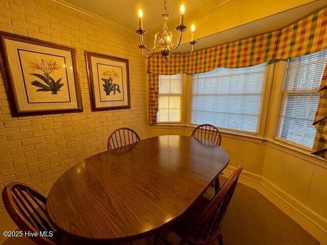 unfurnished dining area featuring an inviting chandelier, ornamental molding, and brick wall