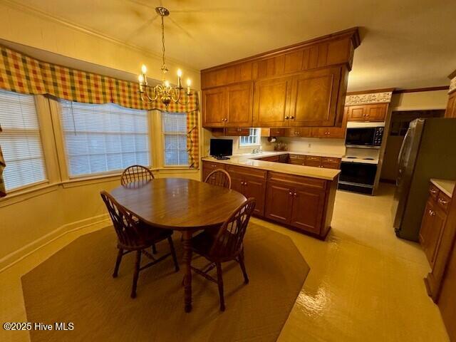 dining space featuring an inviting chandelier and ornamental molding