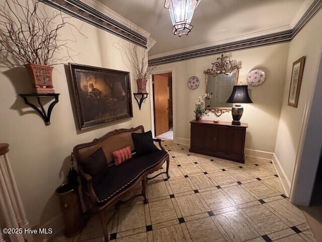 living area with crown molding