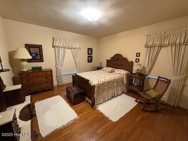 bedroom with hardwood / wood-style floors