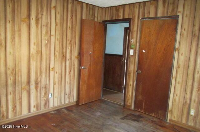 53 Bowmanville Dr, Fairmont, NC 28340 - spare room with wooden walls and dark hardwood / wood-style floors