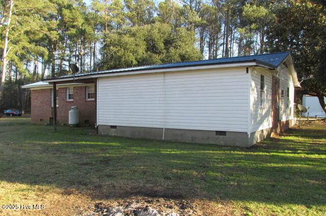 view of property exterior with a lawn