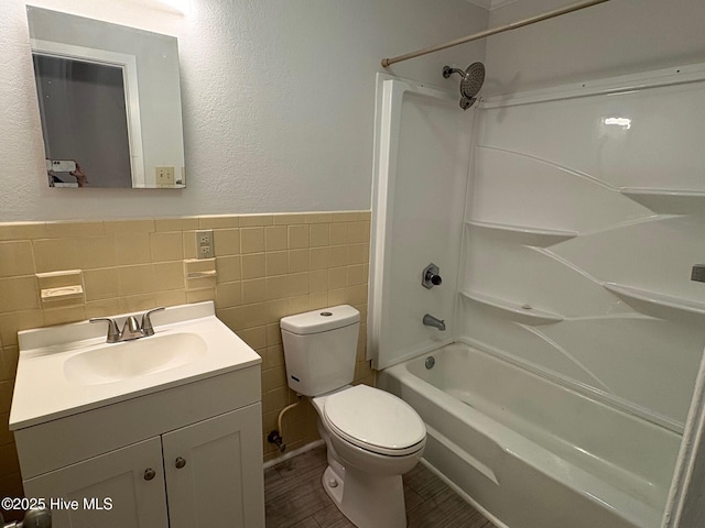 full bathroom featuring vanity, shower / bathing tub combination, hardwood / wood-style flooring, tile walls, and toilet