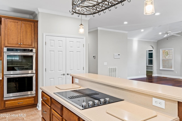 kitchen with double oven, ceiling fan, black electric stovetop, and crown molding