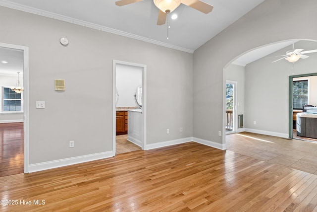 unfurnished living room featuring a healthy amount of sunlight, light hardwood / wood-style floors, and vaulted ceiling