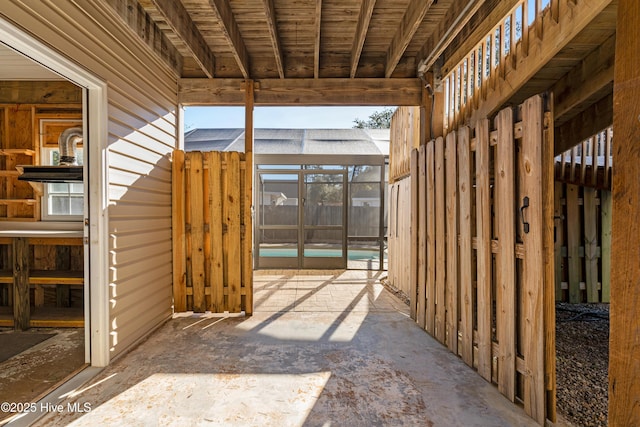 view of patio / terrace with a pool and glass enclosure