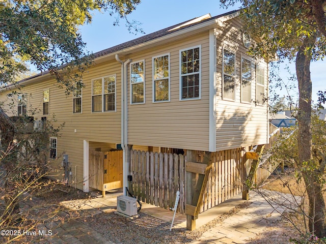 rear view of property with ac unit