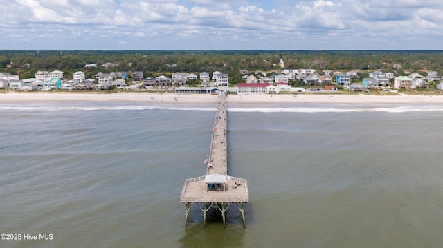 exterior space featuring a water view and a beach view