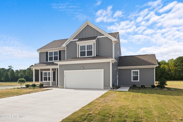 view of front of home with a front yard and a garage