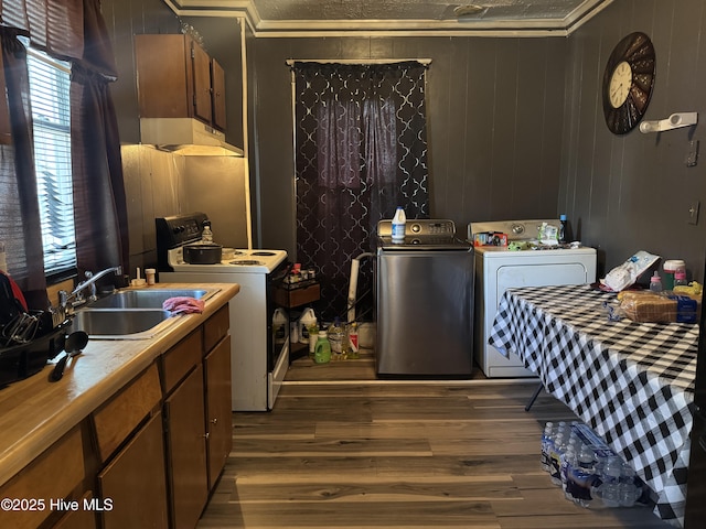 kitchen with sink, dark hardwood / wood-style floors, white electric stove, crown molding, and wood walls