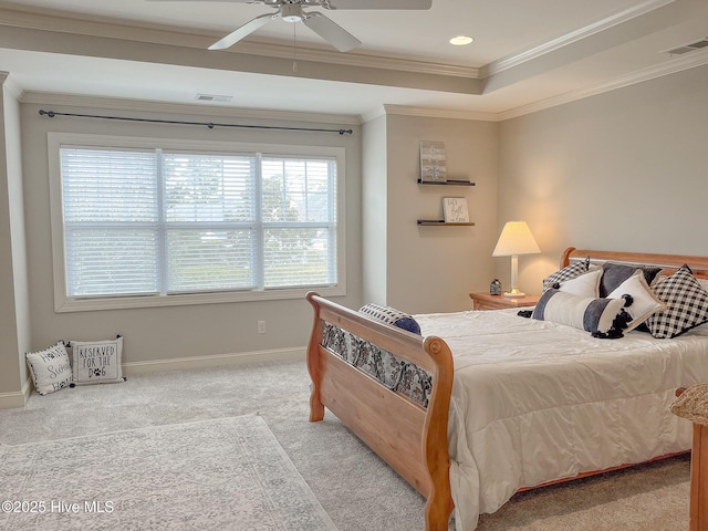 carpeted bedroom with ornamental molding, a raised ceiling, and ceiling fan