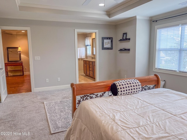 carpeted bedroom with multiple windows, connected bathroom, ornamental molding, and ceiling fan