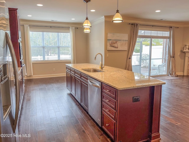 kitchen featuring sink, dishwasher, ornamental molding, an island with sink, and decorative light fixtures