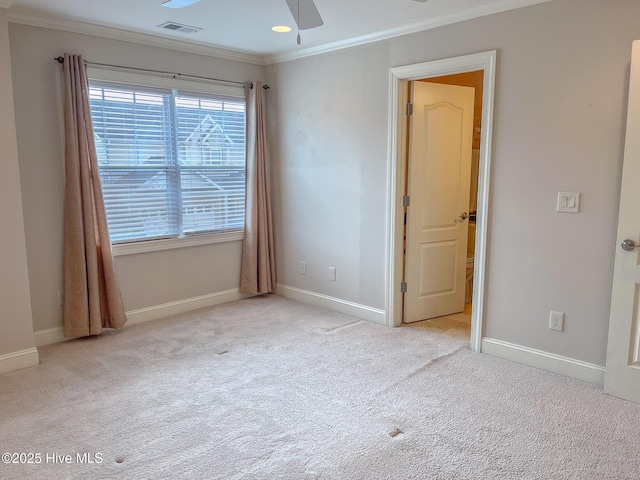 carpeted spare room with crown molding and ceiling fan