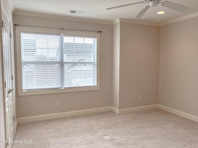 spare room with crown molding, light colored carpet, and ceiling fan