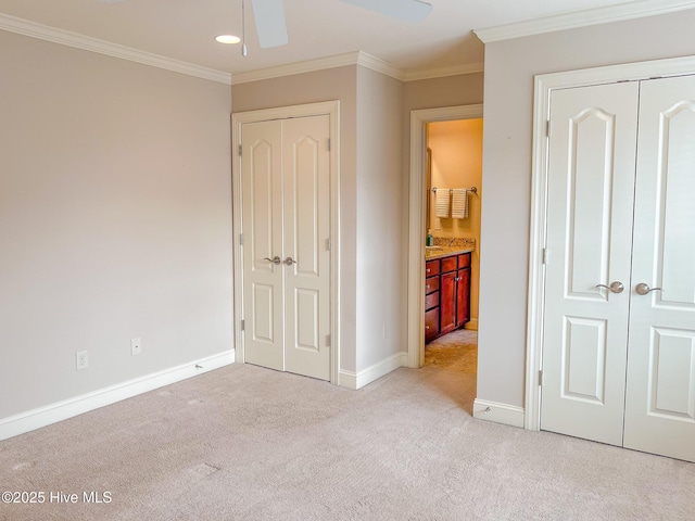 unfurnished bedroom featuring crown molding, ceiling fan, connected bathroom, and light carpet