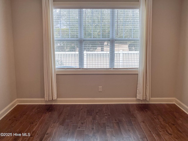 unfurnished room with dark hardwood / wood-style flooring