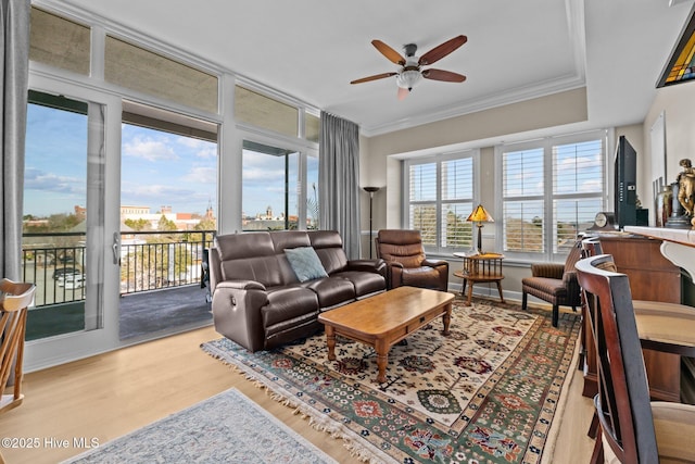 living room with ceiling fan, hardwood / wood-style flooring, and ornamental molding