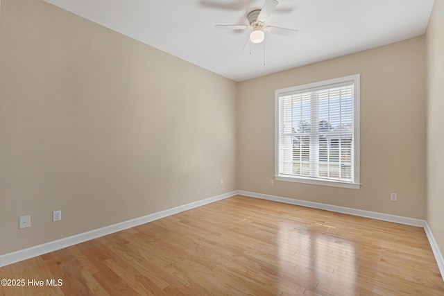 empty room with ceiling fan and light hardwood / wood-style flooring