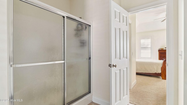 bathroom with ceiling fan and a shower with shower door