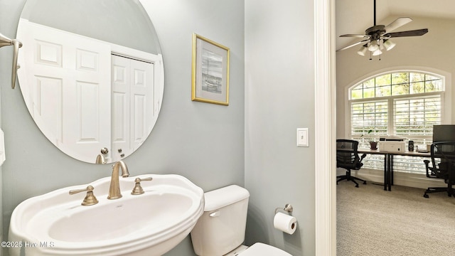 bathroom with sink, ceiling fan, lofted ceiling, and toilet