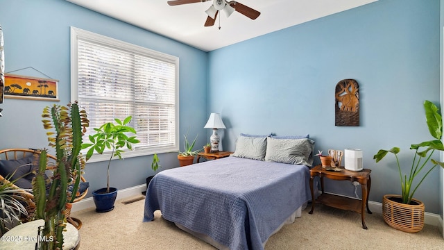 bedroom featuring ceiling fan and light colored carpet