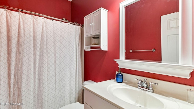 bathroom with toilet and vanity