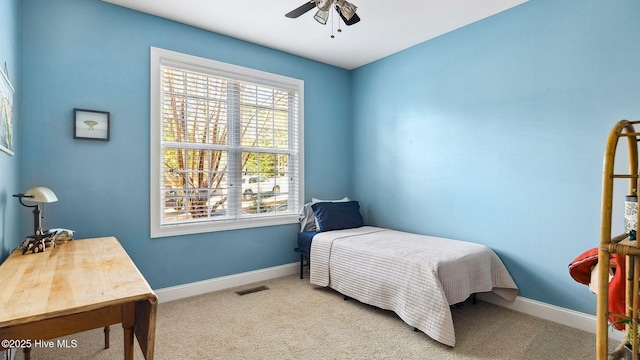 bedroom with ceiling fan and light colored carpet