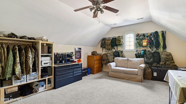 interior space featuring lofted ceiling, carpet floors, and ceiling fan