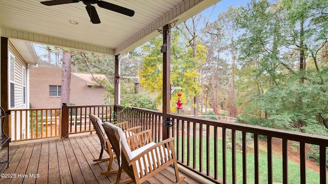 wooden terrace featuring ceiling fan