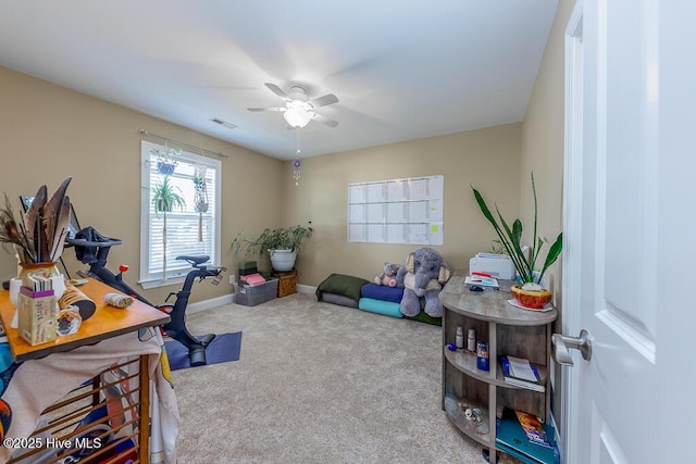 carpeted office with ceiling fan