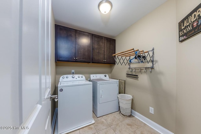 washroom featuring light tile patterned flooring, cabinets, and separate washer and dryer