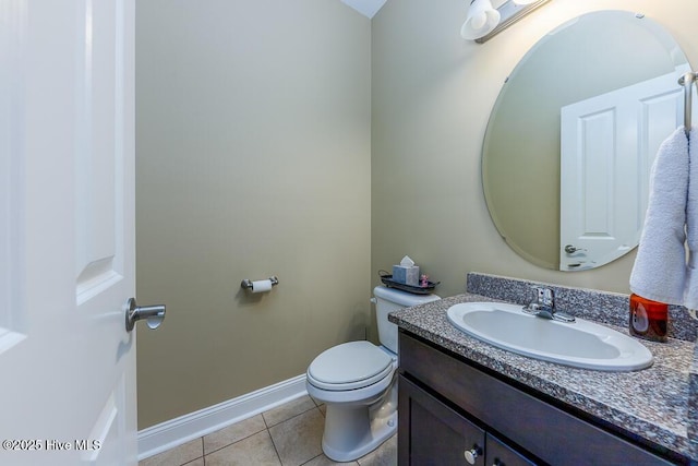 bathroom featuring tile patterned floors, vanity, and toilet