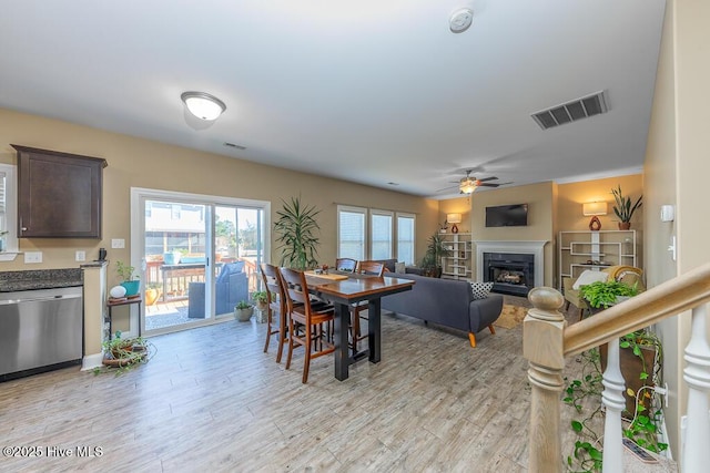 dining space featuring ceiling fan and light wood-type flooring