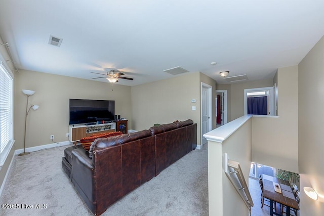 carpeted living room featuring ceiling fan