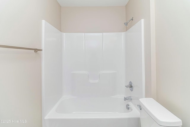 bathroom featuring toilet and bathing tub / shower combination