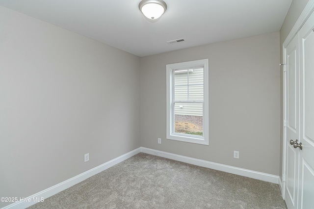 empty room featuring light carpet