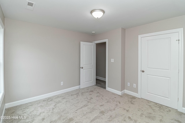 unfurnished bedroom with light carpet