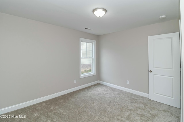 empty room featuring light carpet