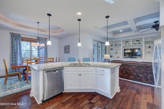 kitchen with an island with sink, sink, white cabinets, stainless steel appliances, and light stone countertops